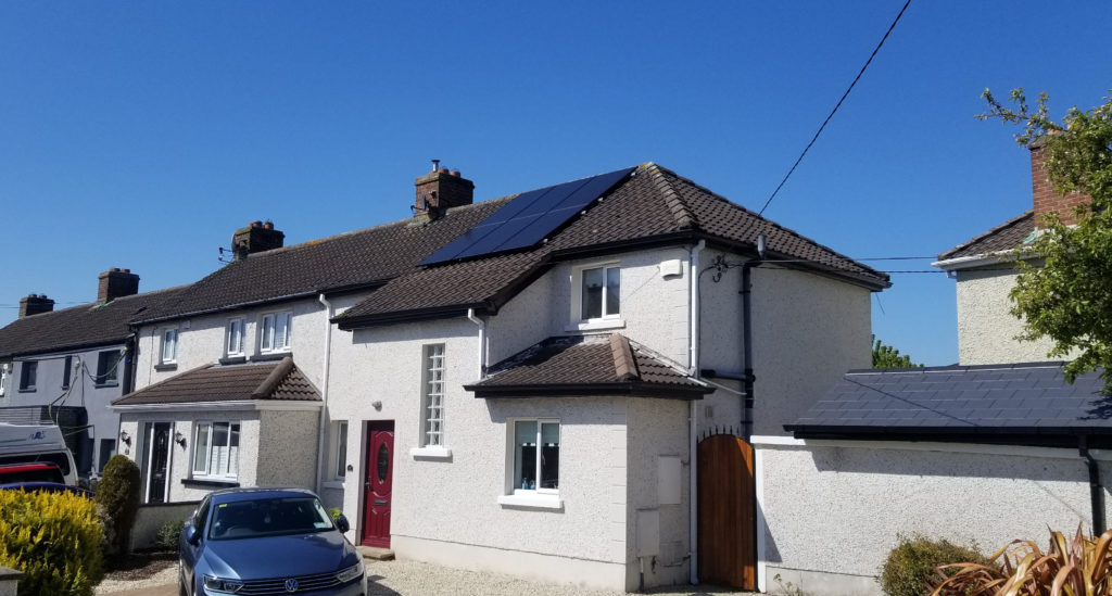6 solar panels on the roof on house in Ireland.  Shows how a string of solar panels look on the roof of a house.