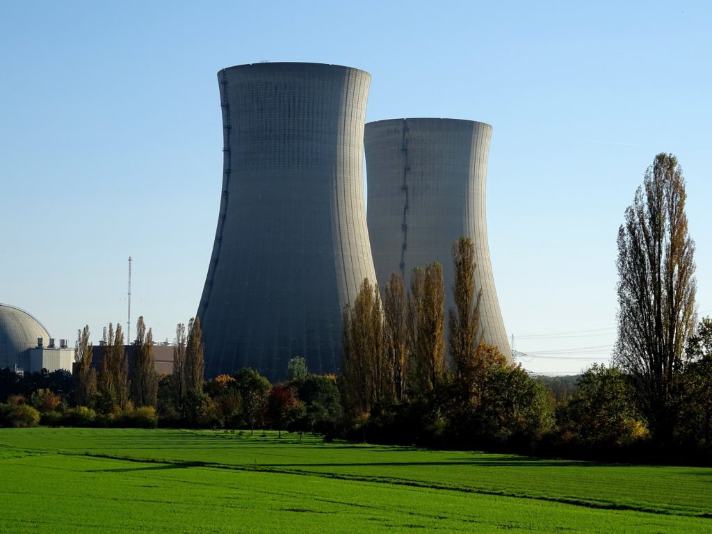 Cooling towers and containment dome at a nuclear power plant.